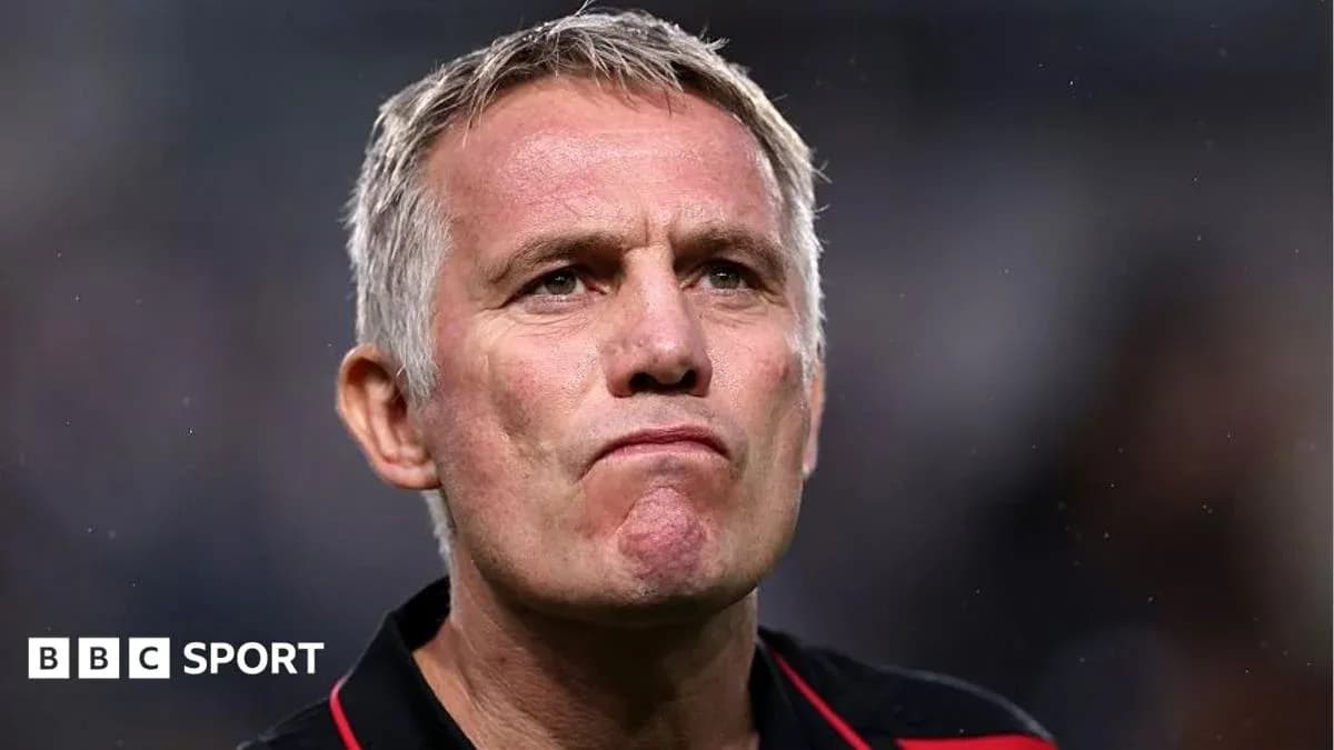 Entraîneur regardant le match avec une expression concentrée Entraîneur regardant le match avec une expression concentrée