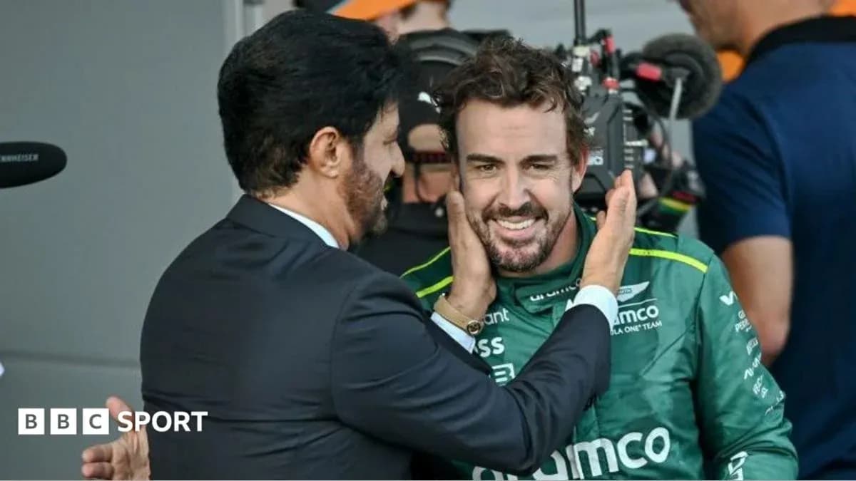 Fernando Alonso smiling with team member after race Fernando Alonso smiling with team member after race