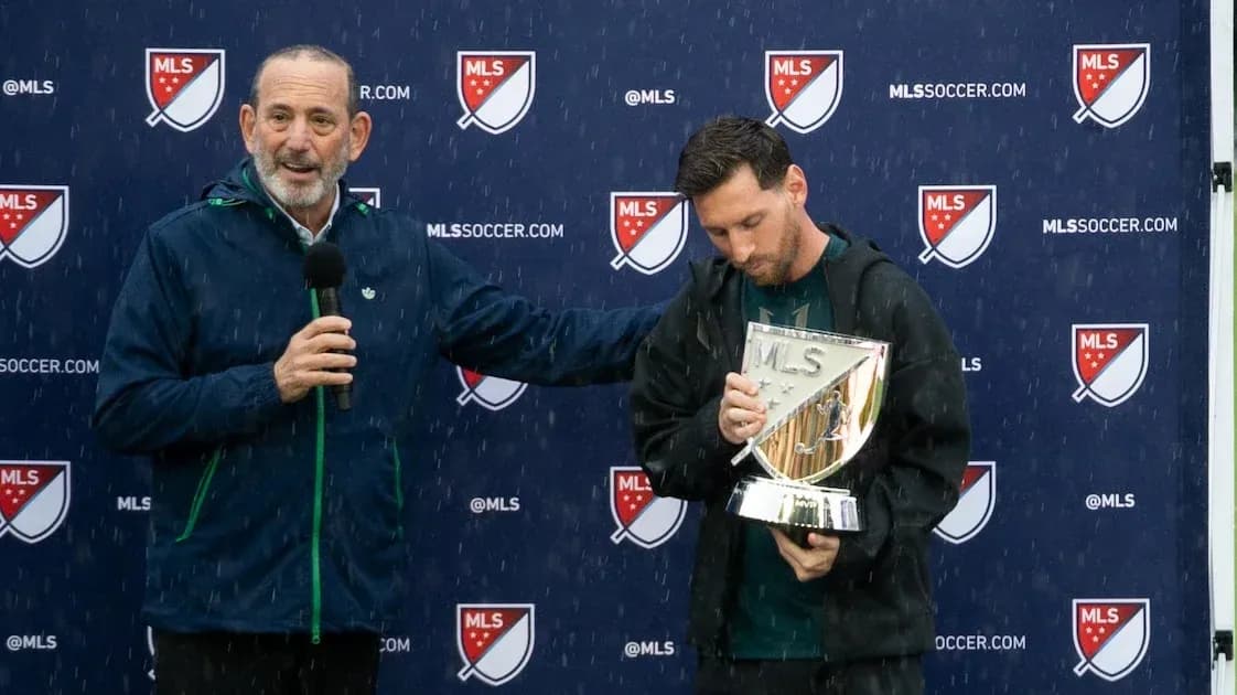 Messi holding MLS trophy during press conference Messi holding MLS trophy during press conference