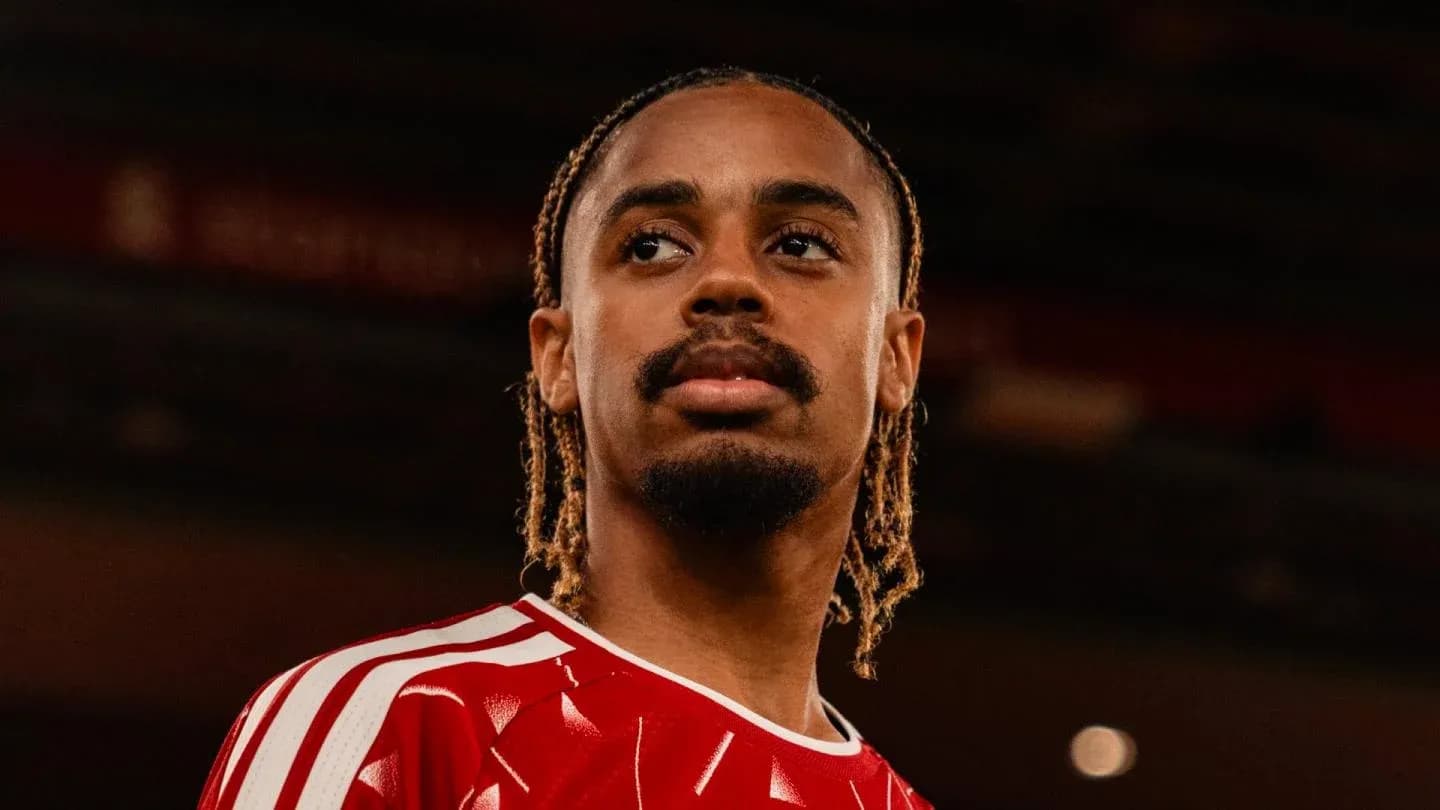 Joueur en maillot rouge regardant au loin Joueur en maillot rouge regardant au loin