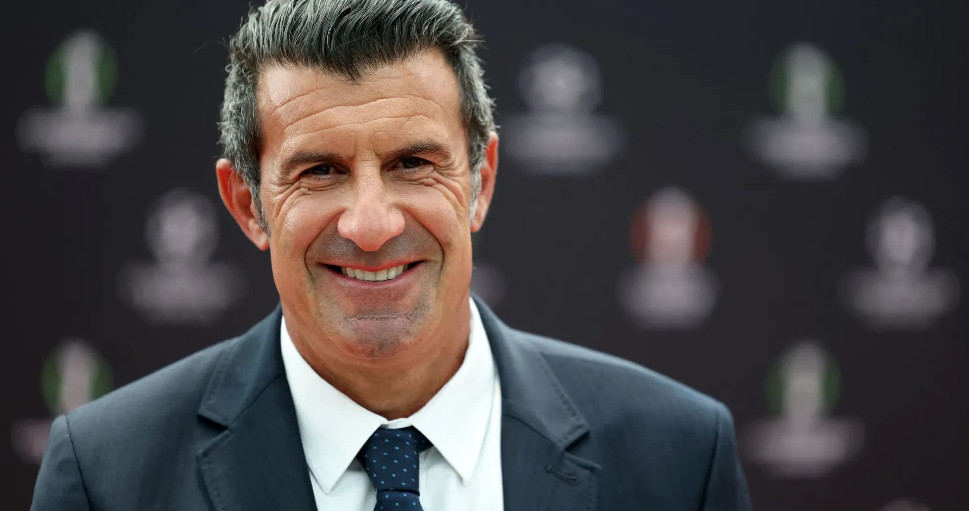 Homme souriant en costume lors d'un événement Homme souriant en costume lors d'un événement